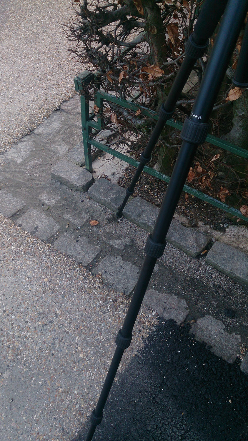 Behind the scenes: Detailed view of tripod placement using cobblestones (Portrait).